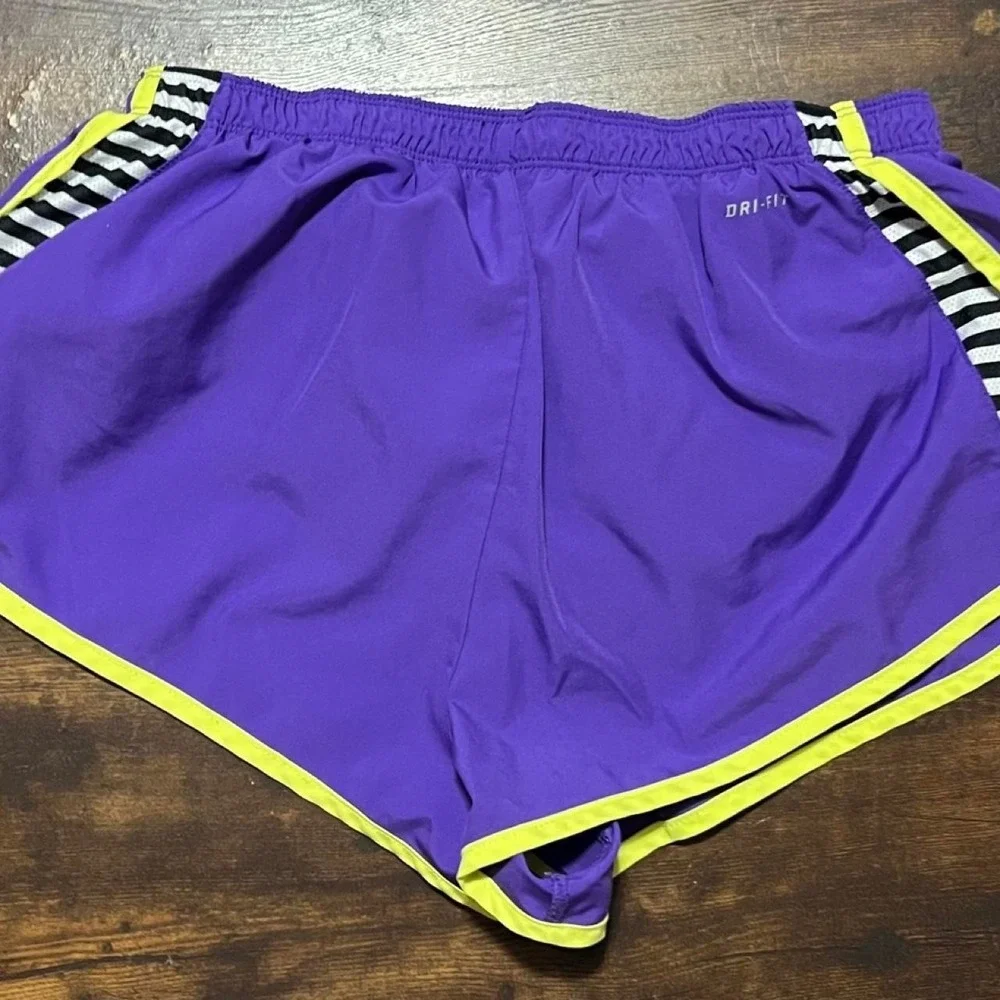 Nike Dri-Fit purple shorts with neon yellow trim 311.5